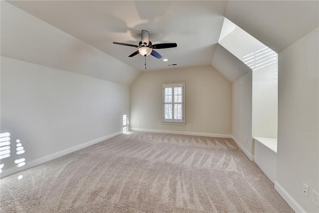 additional living space featuring carpet, lofted ceiling, visible vents, ceiling fan, and baseboards