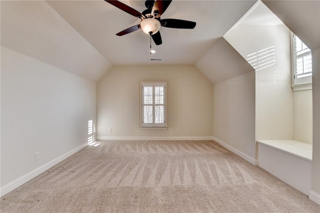 additional living space featuring a healthy amount of sunlight, visible vents, and carpet flooring