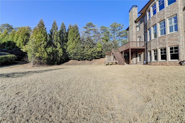 view of yard featuring stairs and a deck