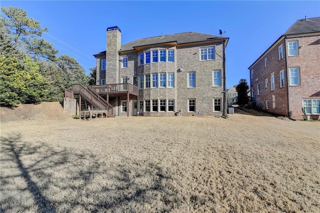 back of house featuring central air condition unit, stairs, a chimney, and a wooden deck