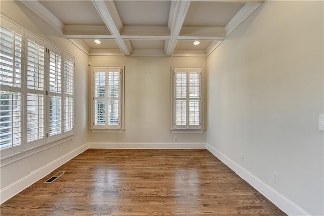 spare room featuring a wealth of natural light, beam ceiling, coffered ceiling, and baseboards