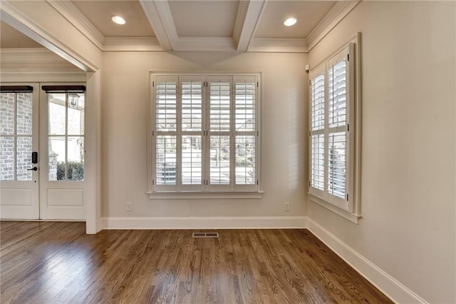 interior space featuring a wealth of natural light, visible vents, beamed ceiling, and wood finished floors