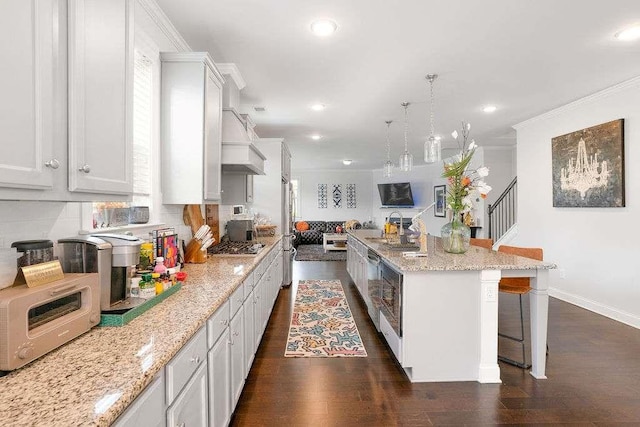 3692 Wartrace Dr, South Fulton, GA 30331 - kitchen featuring custom exhaust hood, recessed lighting, a breakfast bar area, appliances with stainless steel finishes, and dark wood-style floors