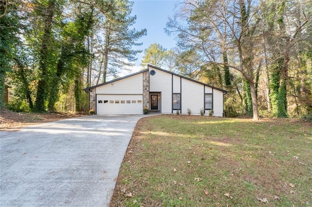 view of front of property with a front yard and a garage