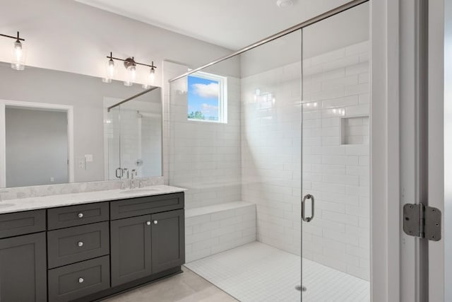 bathroom with tile patterned flooring, vanity, and an enclosed shower