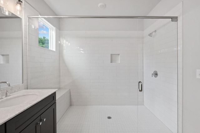 bathroom featuring vanity and an enclosed shower