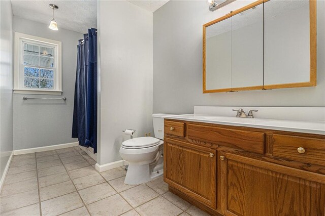 full bathroom with a shower with shower curtain, toilet, vanity, tile patterned flooring, and baseboards