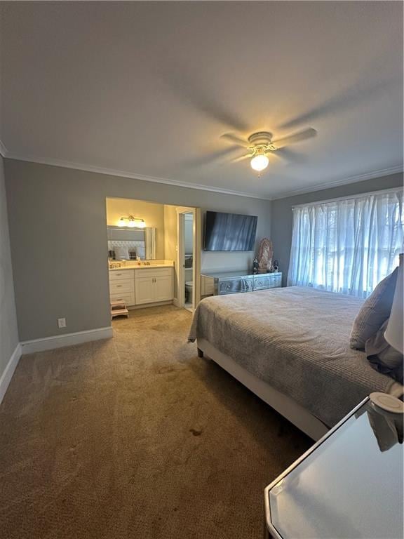 bedroom with crown molding, carpet, ensuite bathroom, and ceiling fan