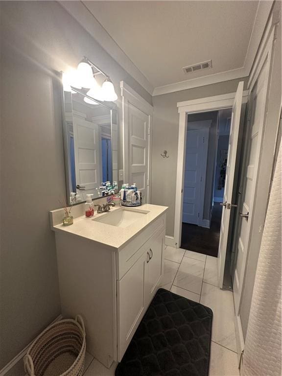 bathroom with crown molding and vanity