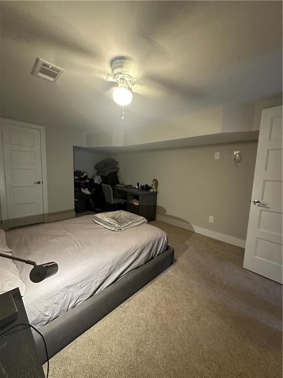 carpeted bedroom featuring ceiling fan