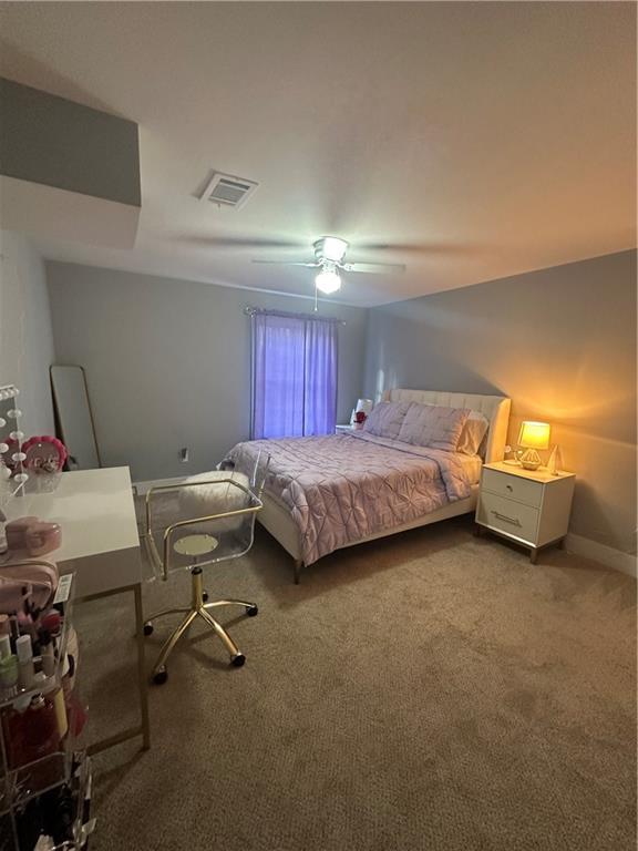 carpeted bedroom with ceiling fan