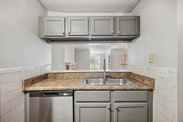 5555 Mountain Springs Cir, Stone Mountain, GA 30088 - kitchen featuring dishwasher, tile walls, a sink, gray cabinetry, and a wainscoted wall