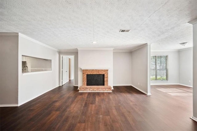 5555 Mountain Springs Cir, Stone Mountain, GA 30088 - unfurnished living room featuring dark wood finished floors, baseboards, a textured ceiling, a fireplace, and ornamental molding