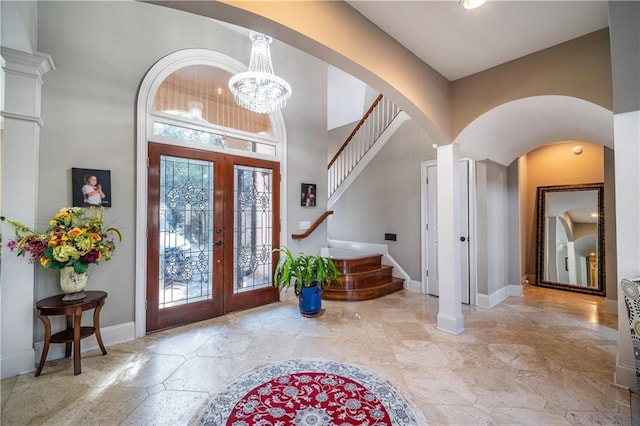 entrance foyer featuring french doors, baseboards, and stairs