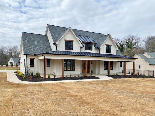 modern farmhouse featuring a porch and a front yard