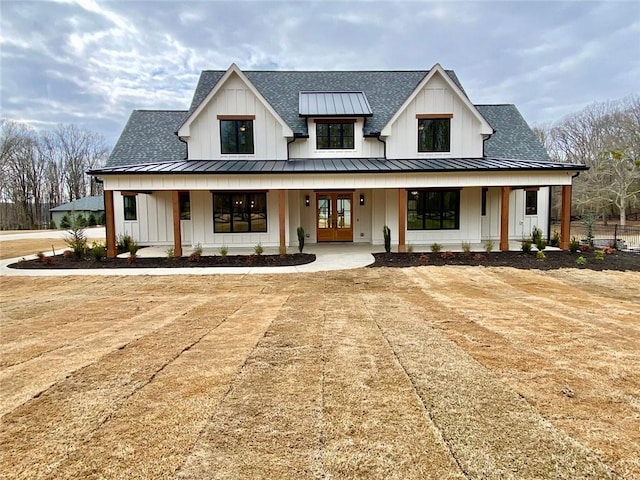 modern farmhouse style home with french doors and covered porch