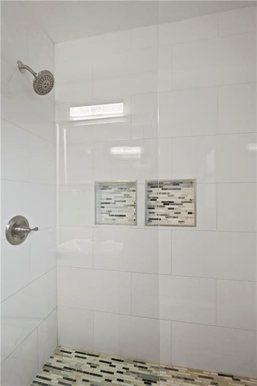 full bathroom with tiled shower