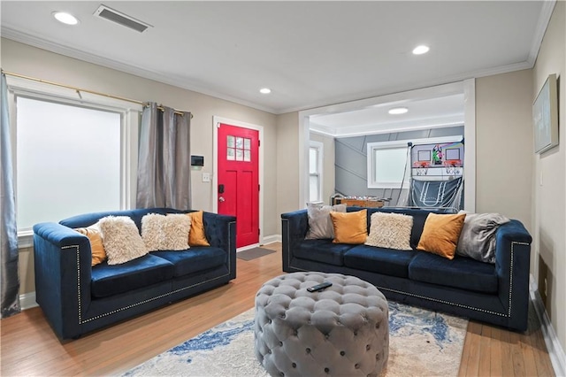 living area with crown molding, visible vents, wood finished floors, and recessed lighting