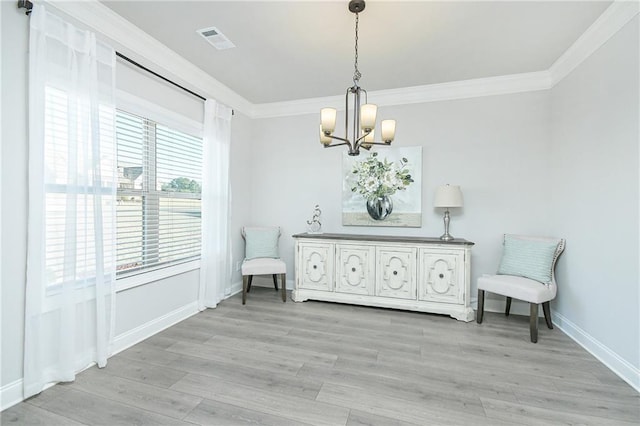 sitting room featuring light wood finished floors, visible vents, a notable chandelier, and ornamental molding