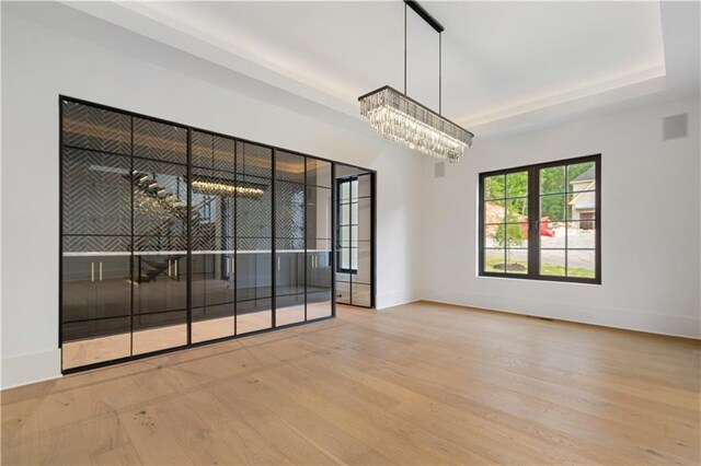 interior space with an inviting chandelier and light hardwood / wood-style flooring