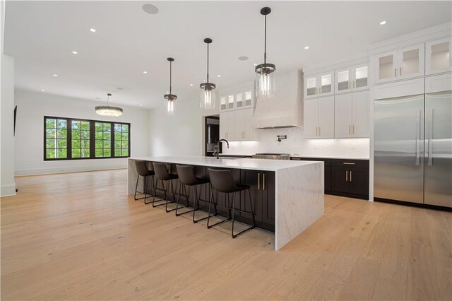 mudroom featuring sink and light hardwood / wood-style flooring