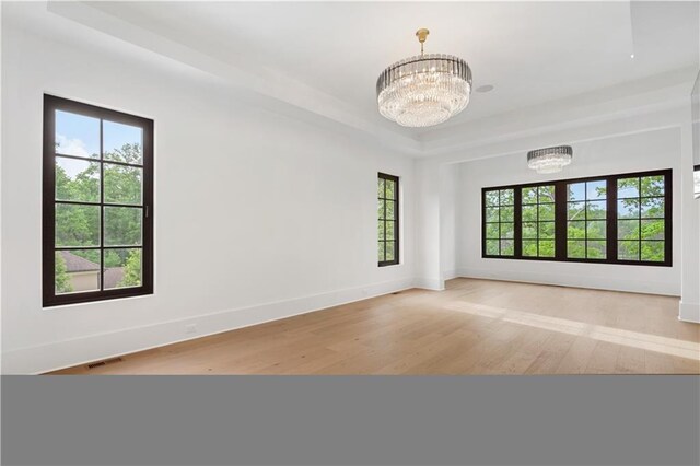 staircase featuring a high ceiling, hardwood / wood-style flooring, and a notable chandelier