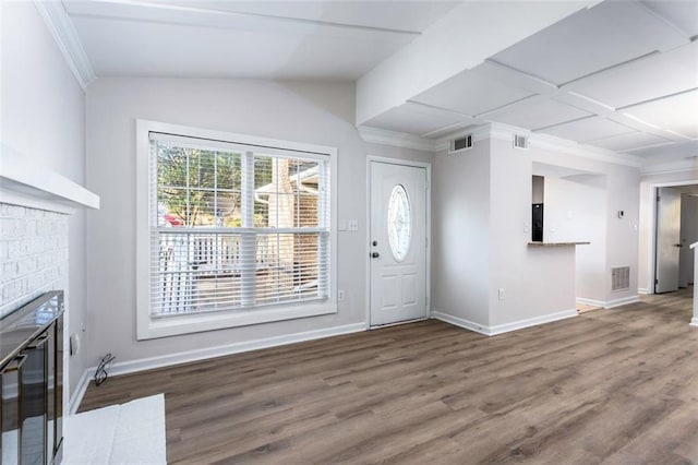 entrance foyer featuring beam ceiling, wood-type flooring, a fireplace, and coffered ceiling