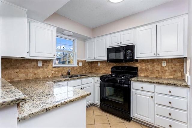 kitchen with black appliances, sink, and white cabinetry