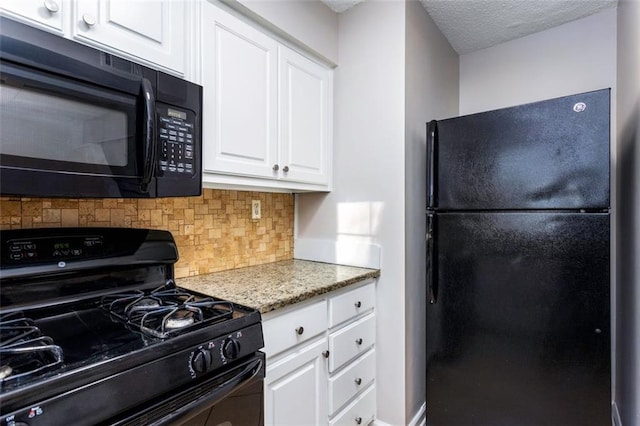 kitchen with light stone countertops, decorative backsplash, white cabinets, and black appliances