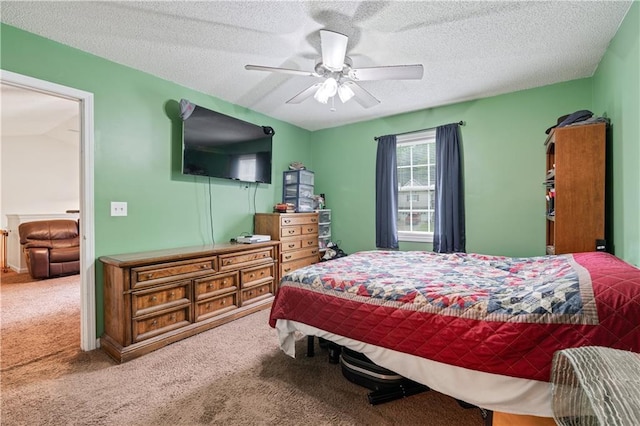 carpeted bedroom featuring ceiling fan and a textured ceiling