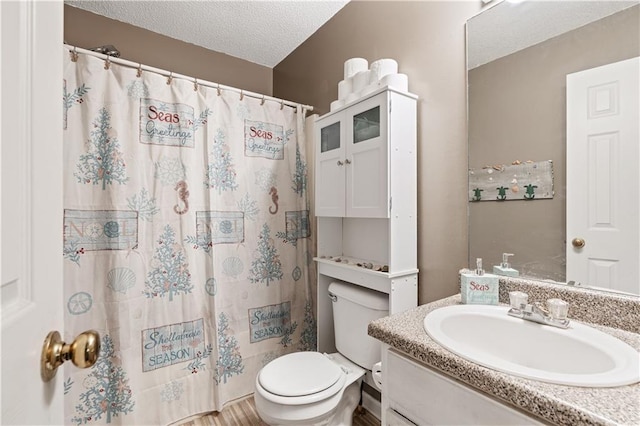 bathroom featuring a textured ceiling, vanity, toilet, and a shower with curtain