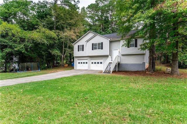 split foyer home with driveway, an attached garage, and a front yard