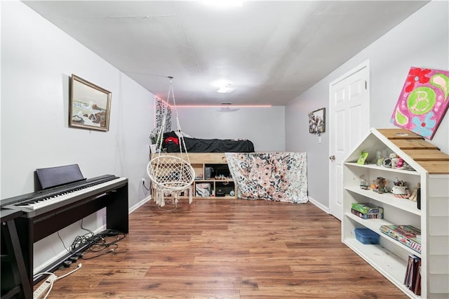 interior space with wood finished floors and baseboards