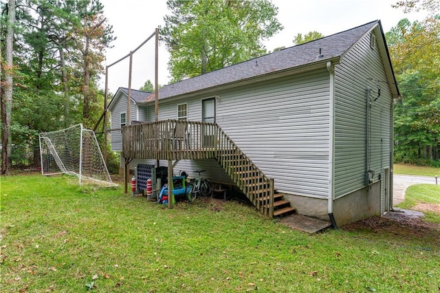 back of property featuring a deck, a yard, and stairway