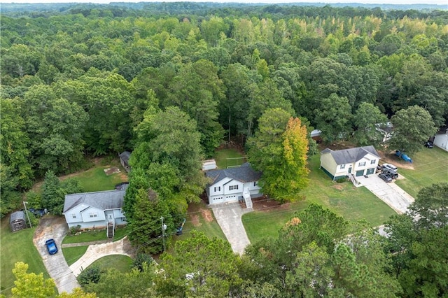 birds eye view of property with a forest view