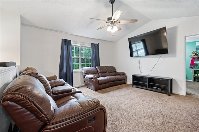 living area featuring carpet, baseboards, vaulted ceiling, and a ceiling fan