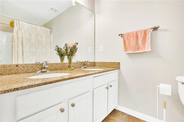 bathroom with tile patterned floors and vanity