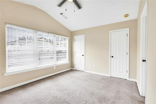 unfurnished bedroom with light carpet, vaulted ceiling, and ceiling fan