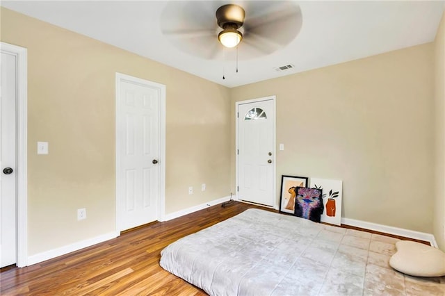 bedroom with hardwood / wood-style floors and ceiling fan