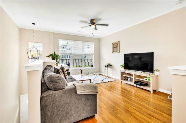 living room with ceiling fan with notable chandelier and wood-type flooring