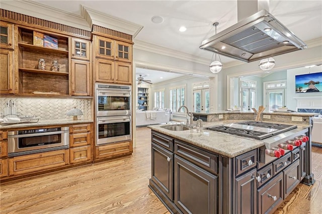 kitchen featuring appliances with stainless steel finishes, sink, light wood-type flooring, and ornamental molding