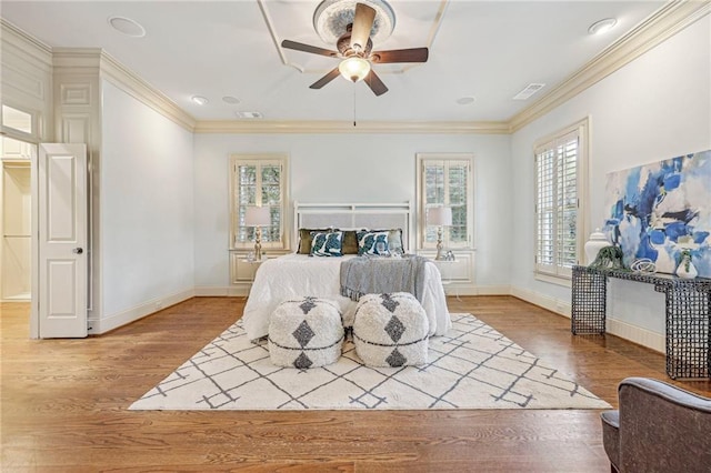 bedroom featuring ornamental molding, hardwood / wood-style floors, and ceiling fan