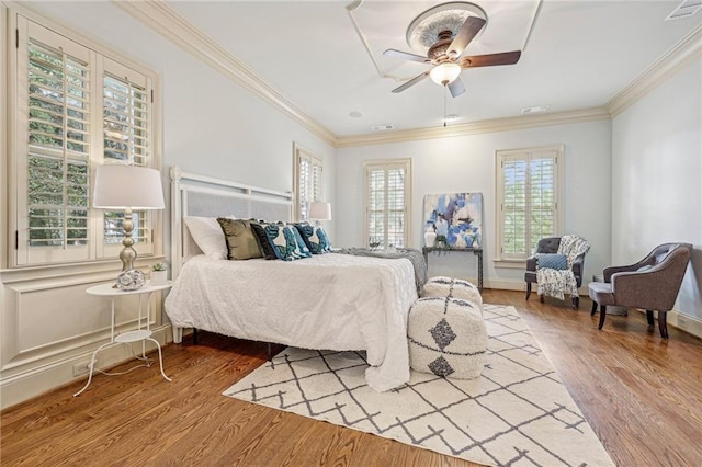 bedroom featuring ornamental molding, hardwood / wood-style floors, and ceiling fan