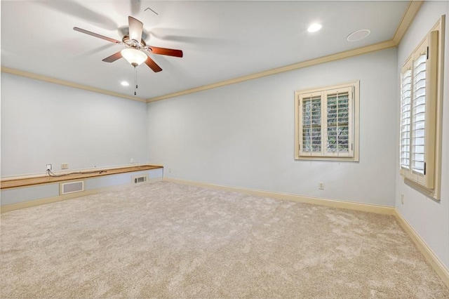 carpeted empty room featuring ornamental molding and ceiling fan