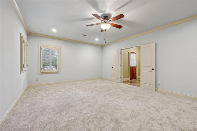 carpeted empty room with crown molding and ceiling fan