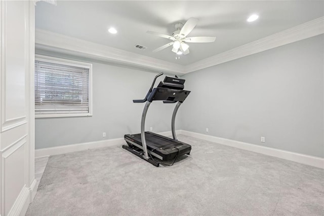 exercise room featuring ornamental molding, light colored carpet, and ceiling fan