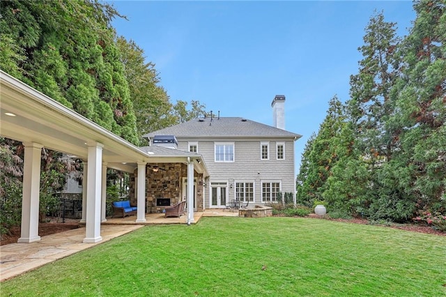 rear view of house with a yard, a patio, and ceiling fan