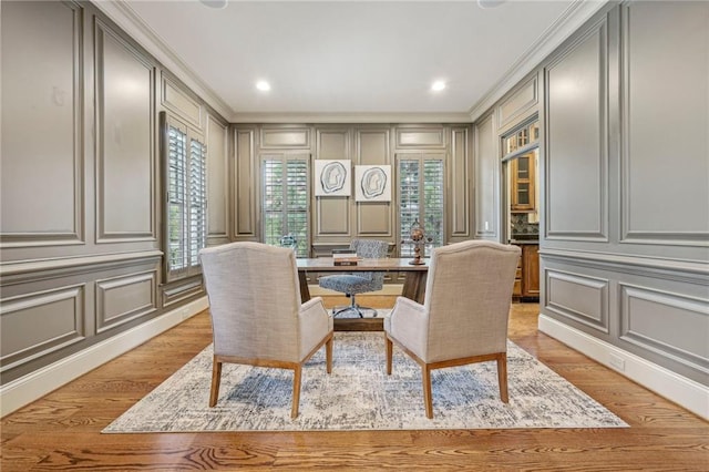 office with ornamental molding and light hardwood / wood-style flooring