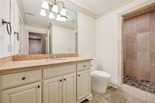 bathroom featuring vanity, a tile shower, ornamental molding, and toilet