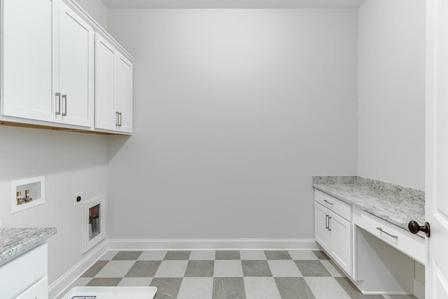 clothes washing area featuring electric dryer hookup, washer hookup, and cabinets